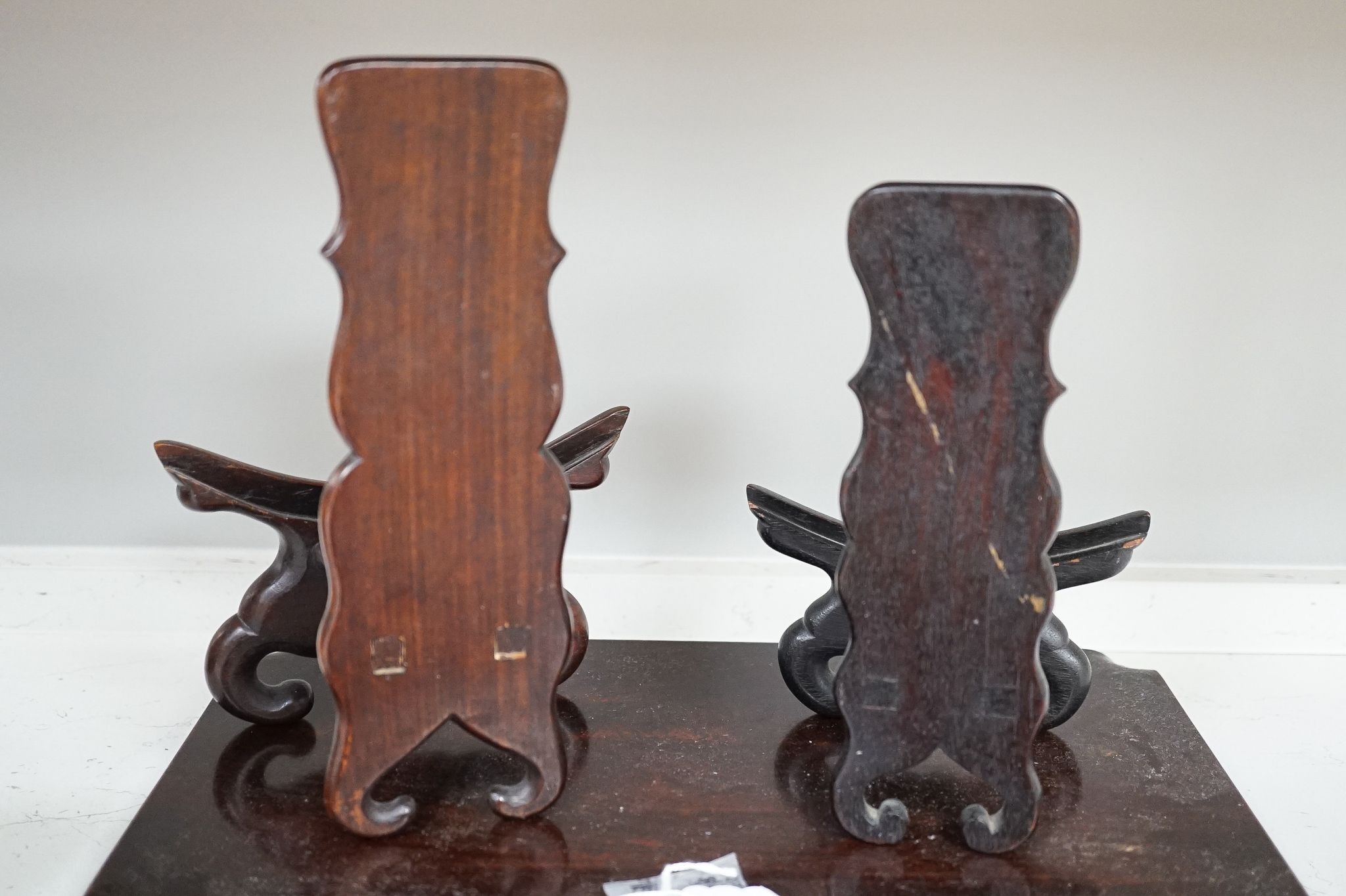 Two Chinese hardwood low stands and two similar plate stands, largest 36cm